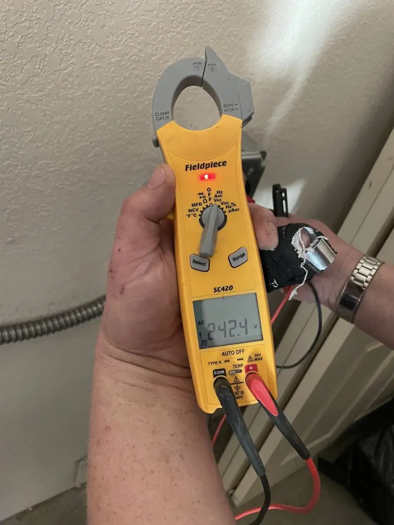 Voltage testing with clamp meter during Generator Installation in Fairfield Glade